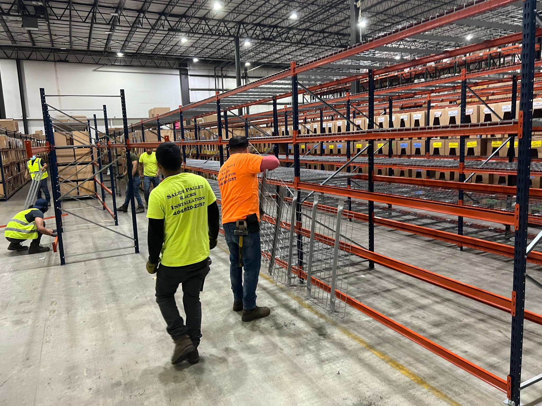 man helping with pallet rack maintenance