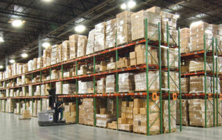 Warehouse full of Husky Rack & Wire teardrop style pallet racking from Pallet Rack World